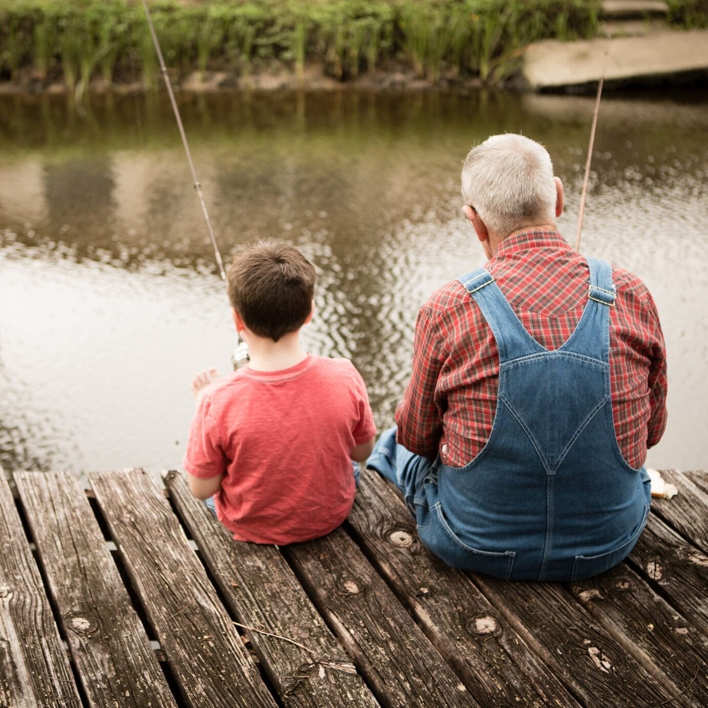 View of Grandpa Fishing With His Great Grandson